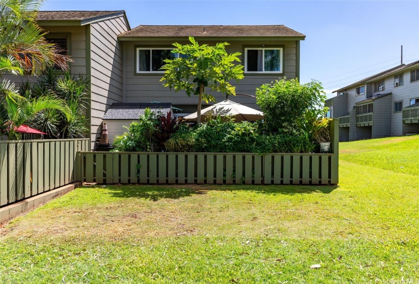 Back of the unit with lush garden. There is a gate to go in and out from back lanai.