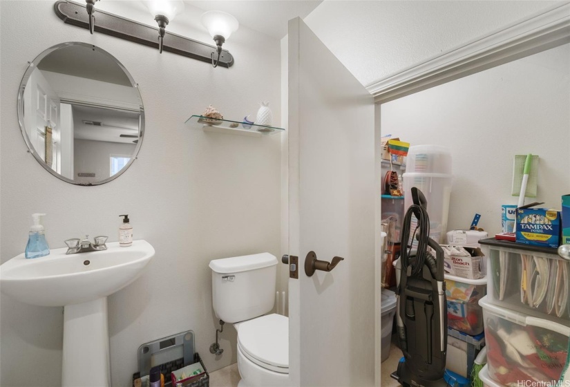 Downstairs half bath with plenty of storage space.