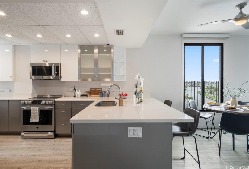 Spacious quartz kitchen counter tops and seating area.