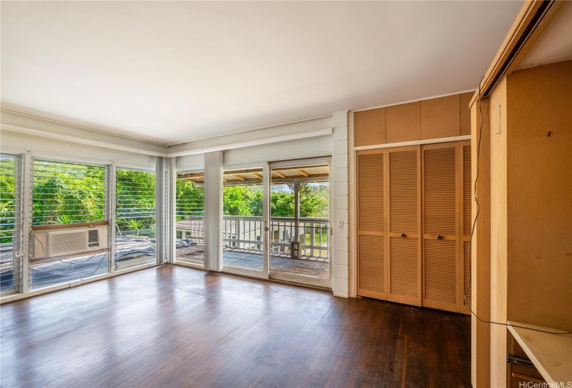 Primary bedroom located at the end of the hall with a corner view.