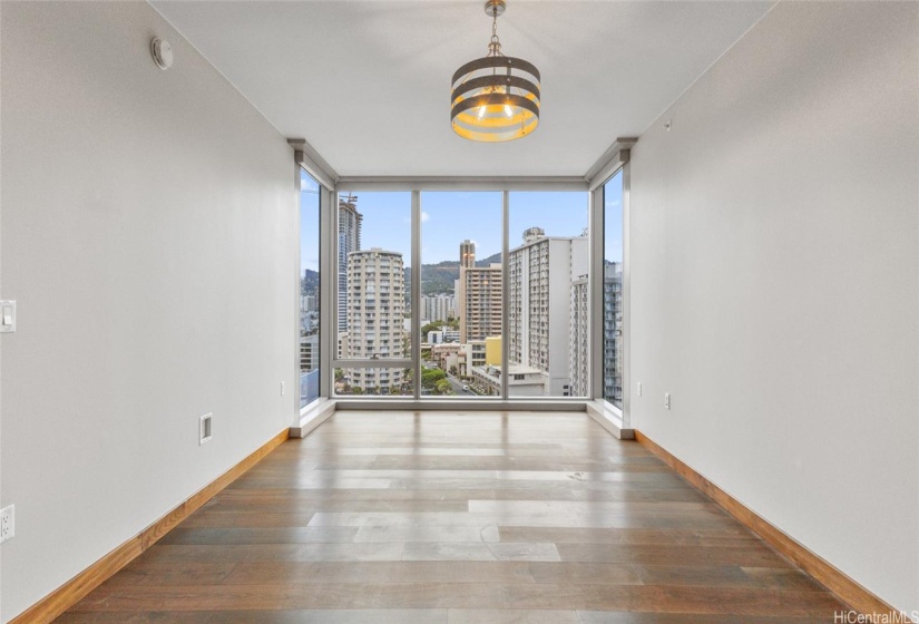 The living room has floor to ceiling windows and motorized shades.