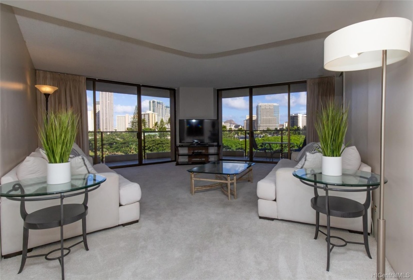 Large living room with Diamond Head and tree top view.