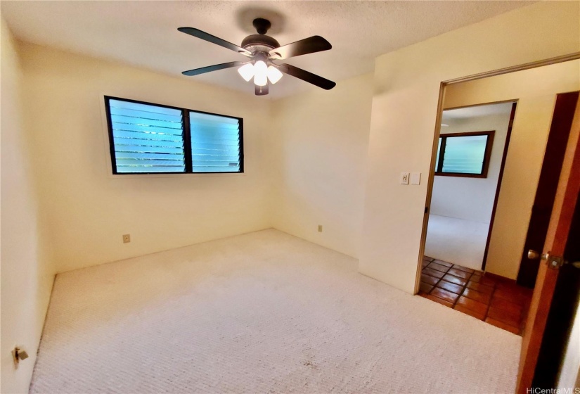 Fourth Bedroom with Ceiling Fan and Garden Views