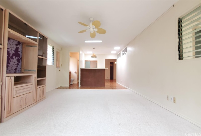 Spacious Living Room with Ceiling Fan, Wet Bar, and Third Bathroom