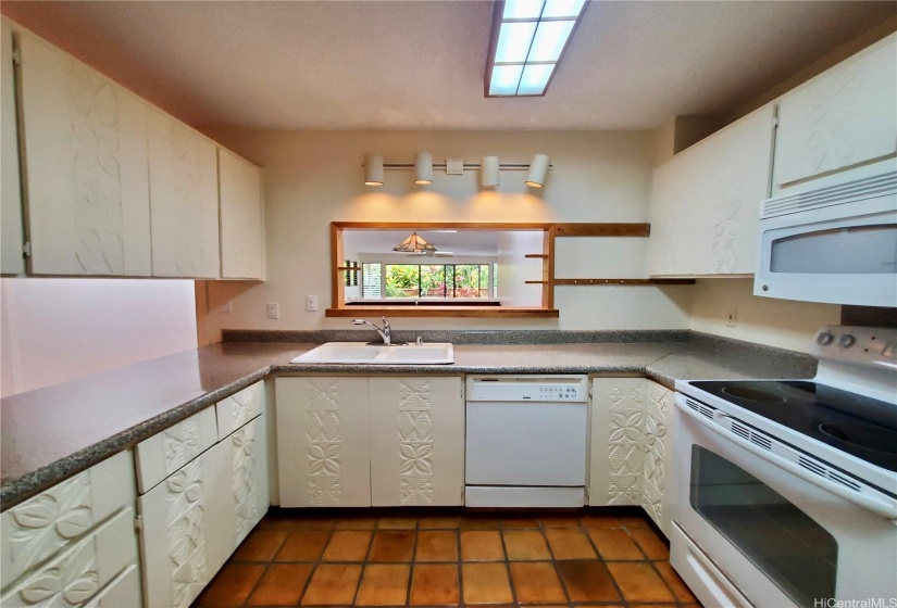 Kitchen with Tropical Motif Carved Cabinetry