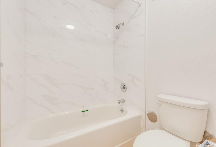 New bathtub, shower tiles and toilet.