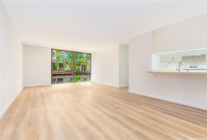 Spacious living room with new laminate flooring.
