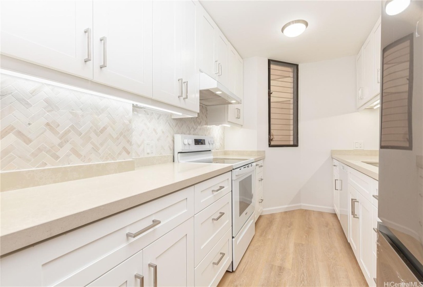 New cabinet, countertop and modern backsplash tile.