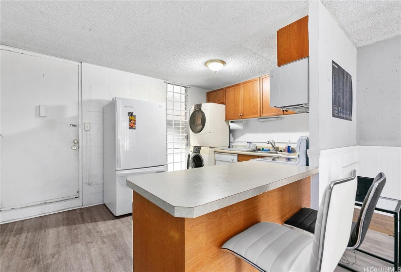 Kitchen located by entrance to the unit.