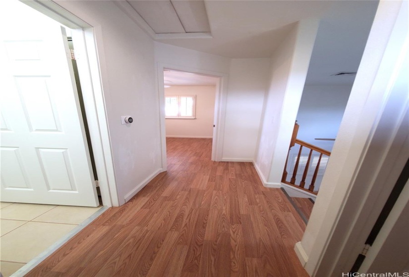 Hallway at top of stairs looking toward 1 of 2 bedrooms and 1 bath