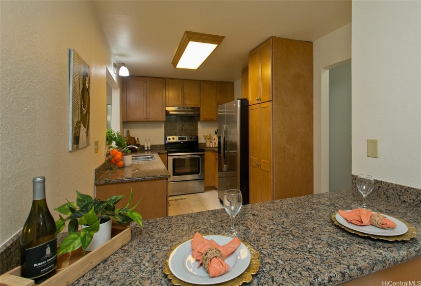 Galley styled kitchen with passage openings to recreational living and formal living spaces. Brand new appliances being delivered and installed very soon. Ample cabinet and counter space makes meal prepping easy.