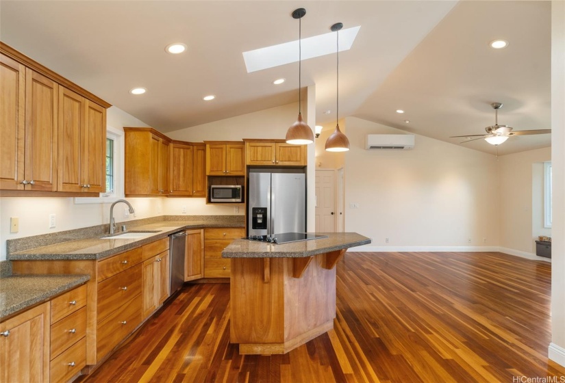 The oven is under the cooktop in the island.