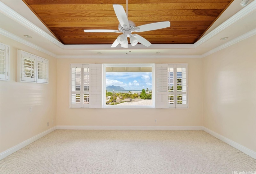 Primary bedroom with vaulted ceilings and awesome ocean views.