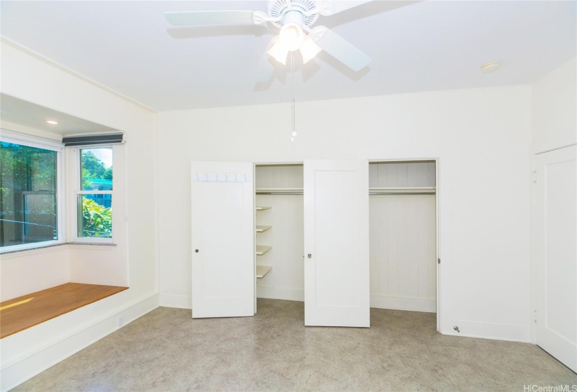 Bedroom with bay window and double closets