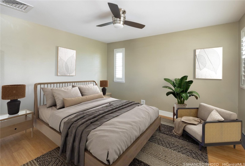 Second bedroom has plantation shutters, wood laminate floors & upgraded closet system.  Virtually staged/enhanced.