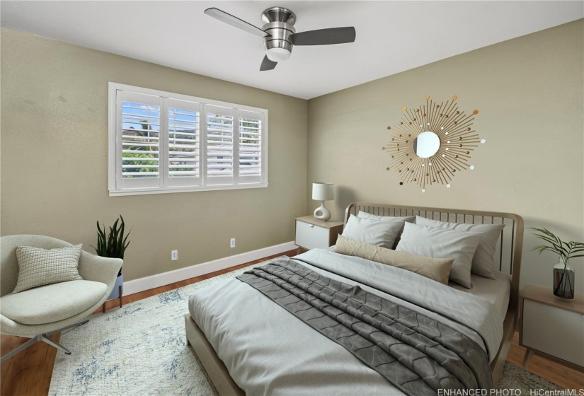 Third bedroom has plantation shutters & wood laminate floors.   Virtually staged/enhanced.