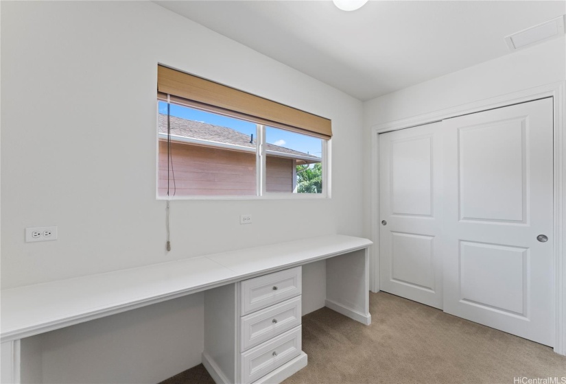 Built-in desk located at the top of the stairs, in a den area. Extra storage to the right.