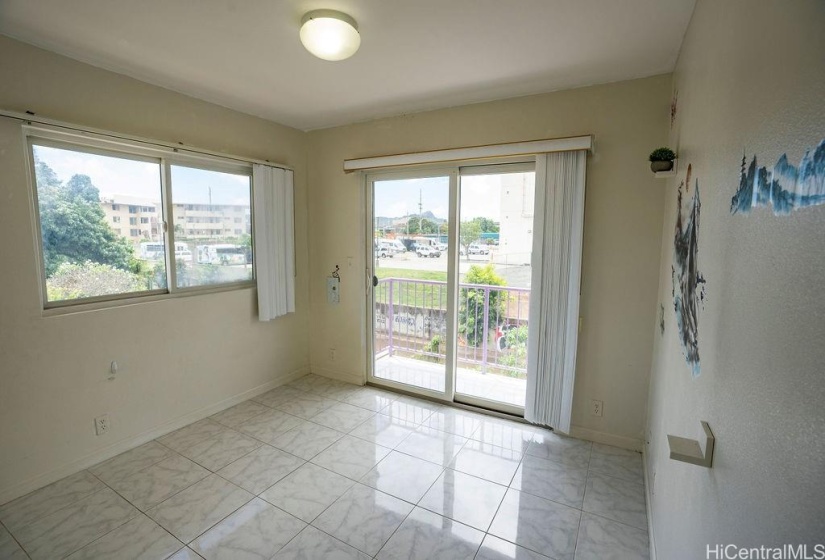 Corner upstairs bedroom with a private balcony.