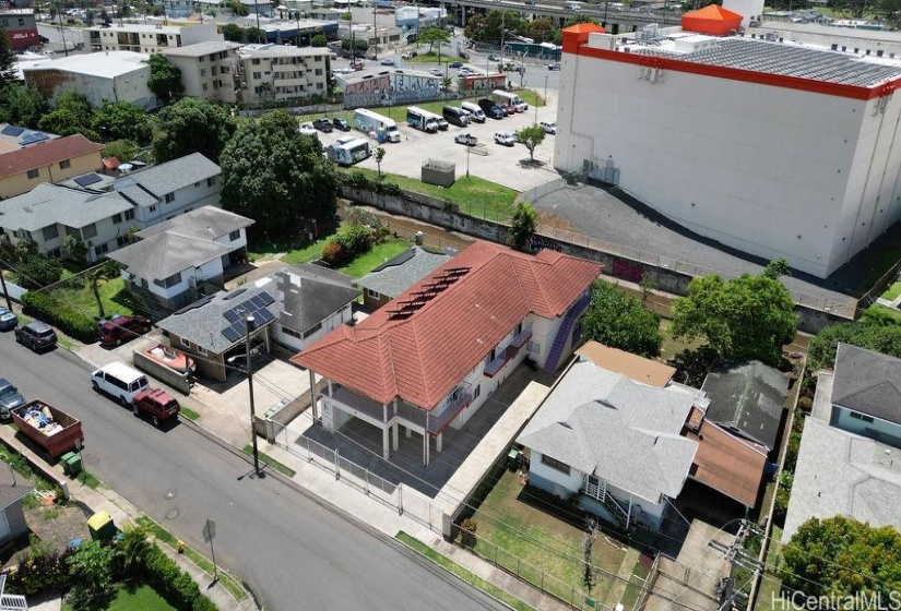 View of the property from Waialae Avenue. House has 3 solar water heaters and a coin operated laundry area.