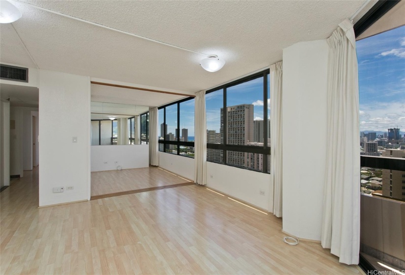 Living room area with connecting second bedroom (sliding doors in open position)