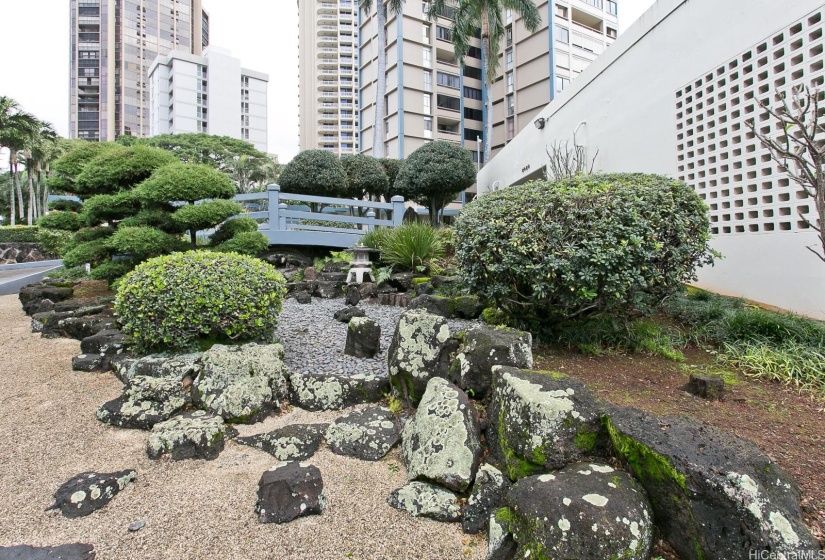 Serene and tranquil, this traditional landscaped Japanese rock garden adorn the front of this renowned condominium.