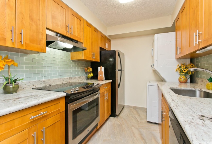 Relish in this kitchen's bountiful upgrades including handsome cabinetry, granite counter tops, and glass tile back splash.