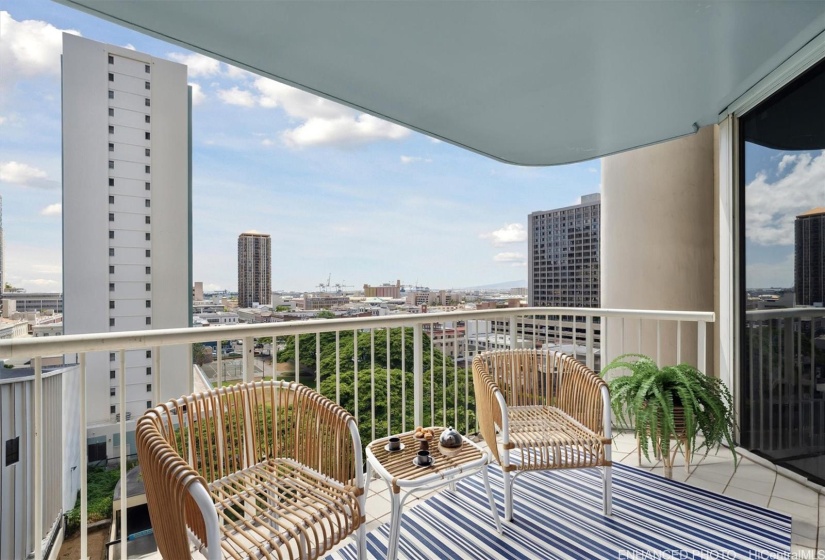 Spacious lanai with spectacular views to Honolulu Harbor and the ocean beyond.  Photo has been digitally enhanced and staged.