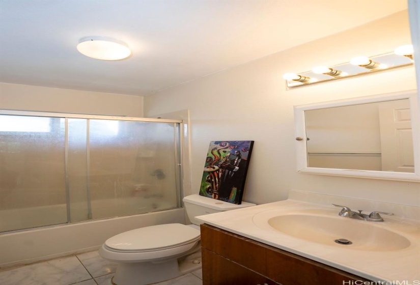 A typical bathroom with ceramic tile flooring.