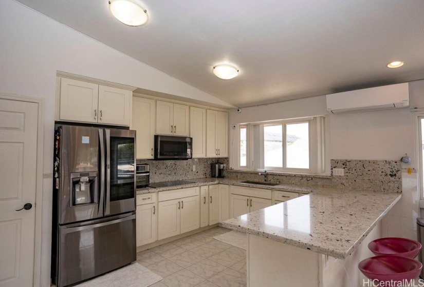 The main kitchen is spacious and features upgraded stainless steel appliances, granite counter tops, vaulted ceilings and recessed lighting.