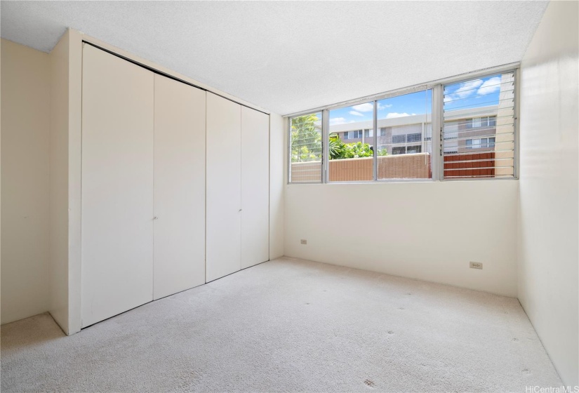 Primary bedroom with built-in cabinets.