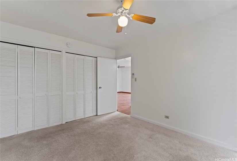 Primary bedroom with double closet.