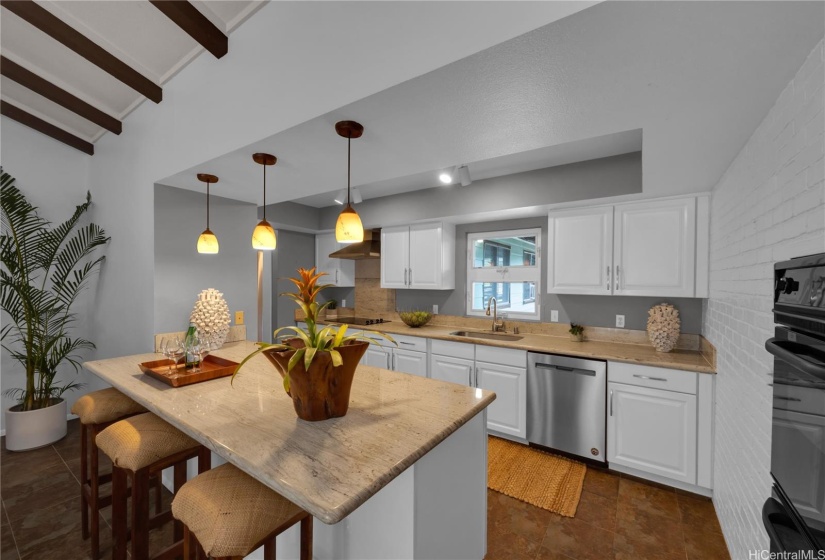 Lovely kitchen with granite counters and window over sink looking to front entry of the home.