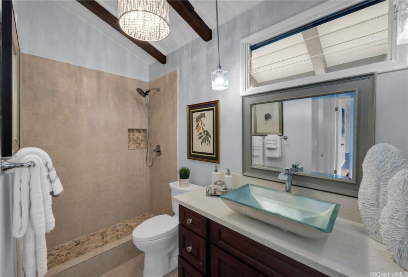 Very Pretty guest and hall bath with vaulted ceiling.