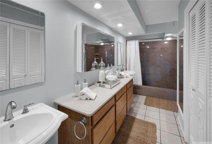 Bathroom in main bedroom suite with closets.