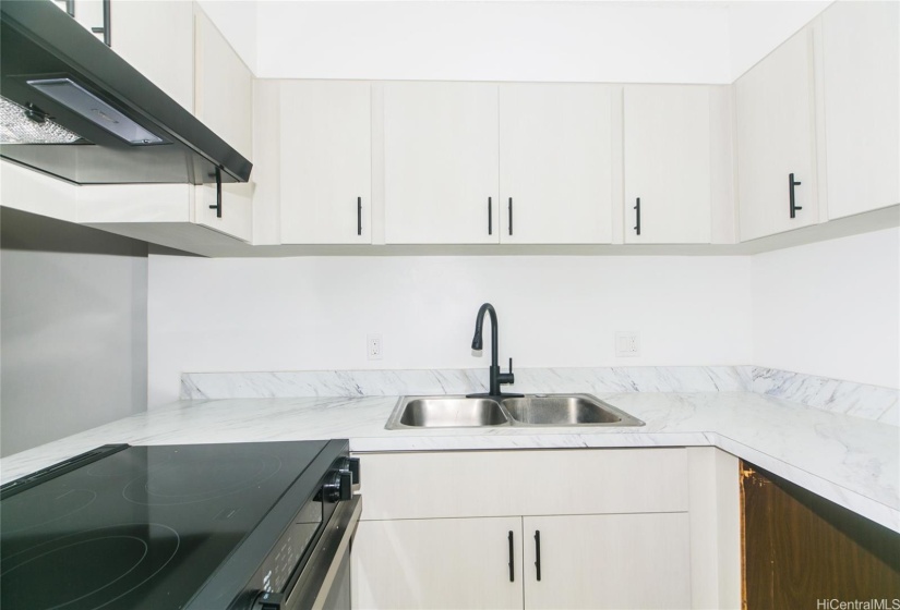 Remodeled kitchen with new range and refrigerator