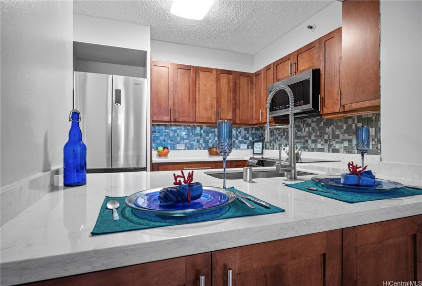 Renovated kitchen with newer stainless steel appliances.