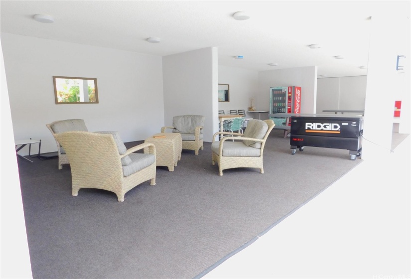 Expansive covered gathering area with tables and chairs, adjacent to the barbeque, pool and sauna.