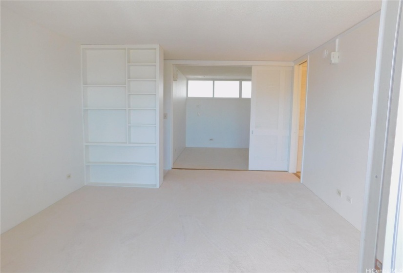 From the lanai towards the bedroom with the louvered sliding doors partially extended.