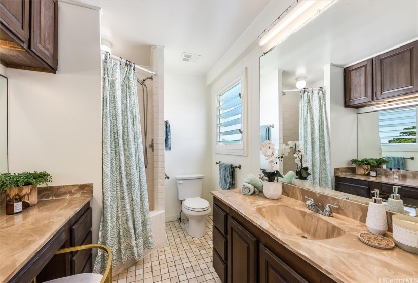 Upstairs bathroom in the second en-suite bedroom boasts separate vanity sink and make-up area.