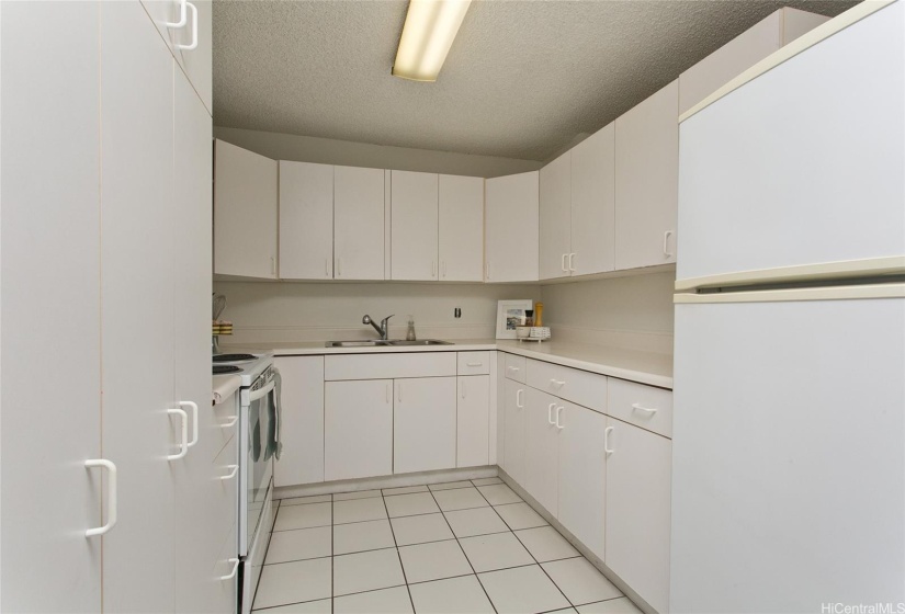 Kitchen - lots of storage! There is also an assigned storage locker near assigned and COVERED parking stall.