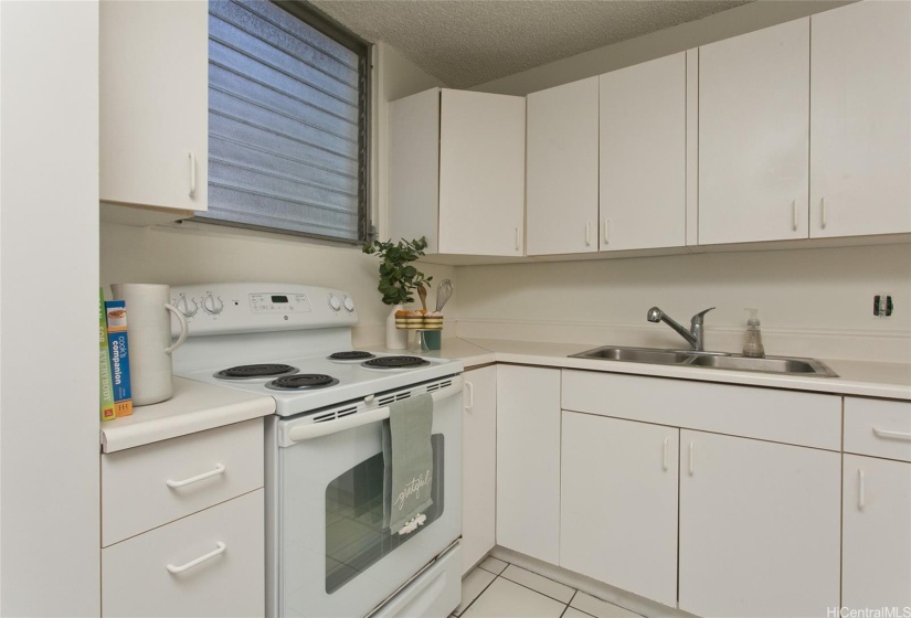 All white cabinets, appliances, walls.