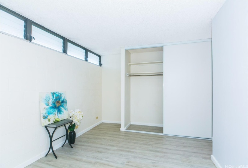 Bedroom with luxury vinyl plank flooring throughout, even in the closet!