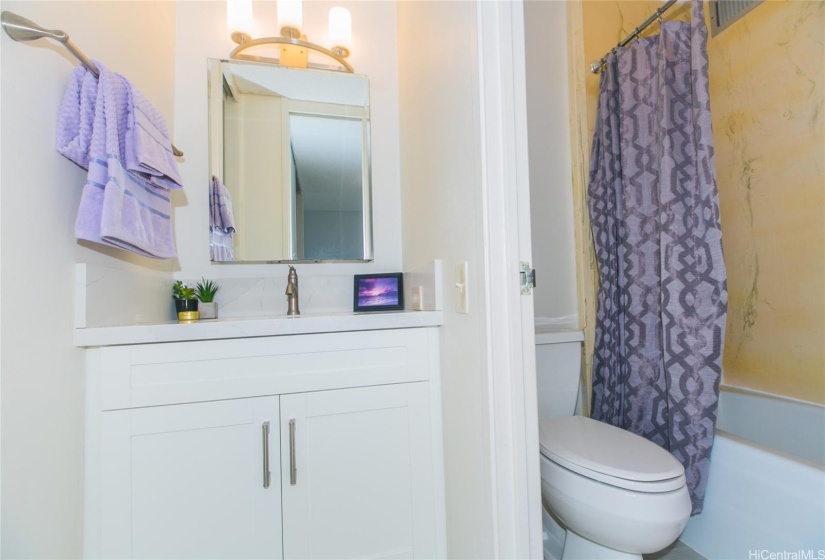 Contemporary lighting and newer vanity with the same white shaker cabinets and quartz counters. Toilet wax ring seals were just replaced by association