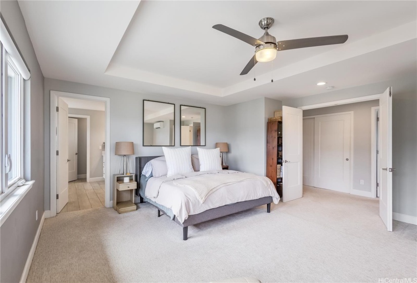 Double doors invite you in.  Bedroom opens to ensuite bath and a huge walk in closet.  Outside the Primary suite t the right is one of two laundry rooms that has a large soaker sink and lots of shelving.