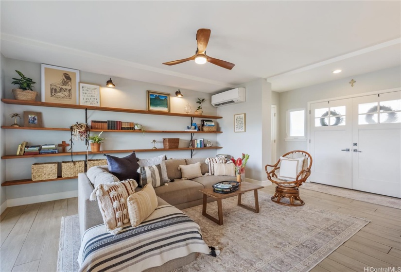 Entry to home invites you to relaxin this comfortable living area.  Built in shelving is a plus.  The half bath is to the left of the entrance double doors.