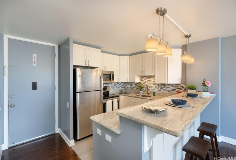 This gorgeous unit has been beautifully renovated with an open kitchen! The kitchen features wood cabinetry, stone countertops, and stainless steel appliances.