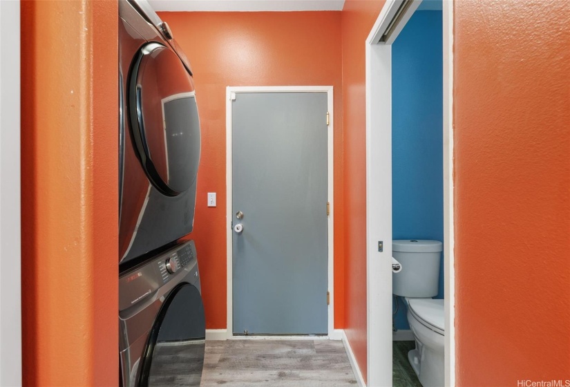 Full size washer dryer and half bath, with door leading to two car garage and solar water heater