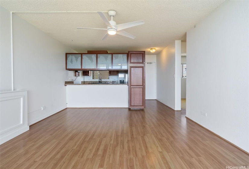 Kitchen with bar island to living room