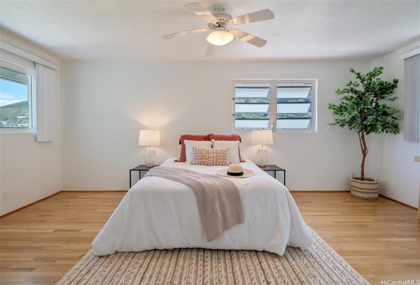 Upstairs is your extra large primary bedroom with cool cross breezes.