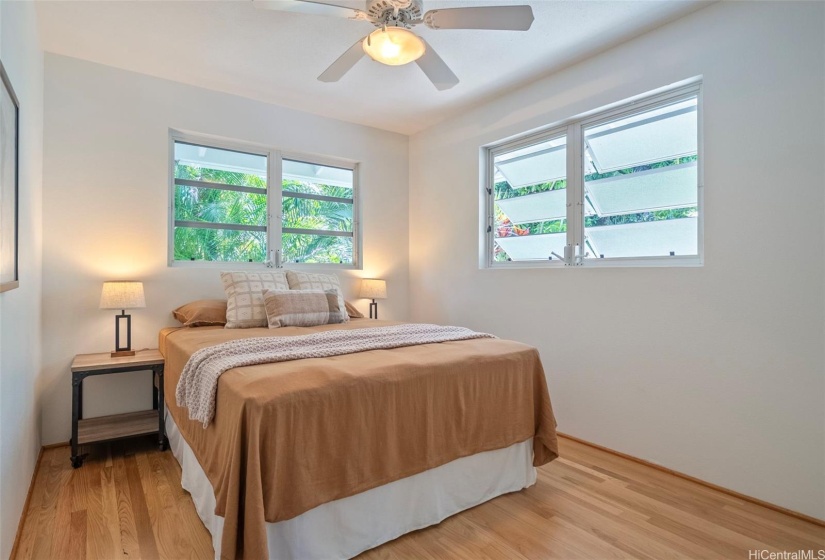 2nd  bedroom upstairs is quiet and cool with tropical views.